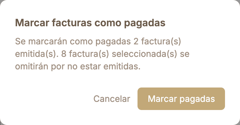 Diálogo de confirmación de Zalach: «Marcar facturas como pagadas. Se marcarán como pagadas 2 factura(s) emitida(s). 8 factura(s) seleccionada(s) se omitirán por no estar emitidas.», con los botones Cancelar y Marcar pagadas.